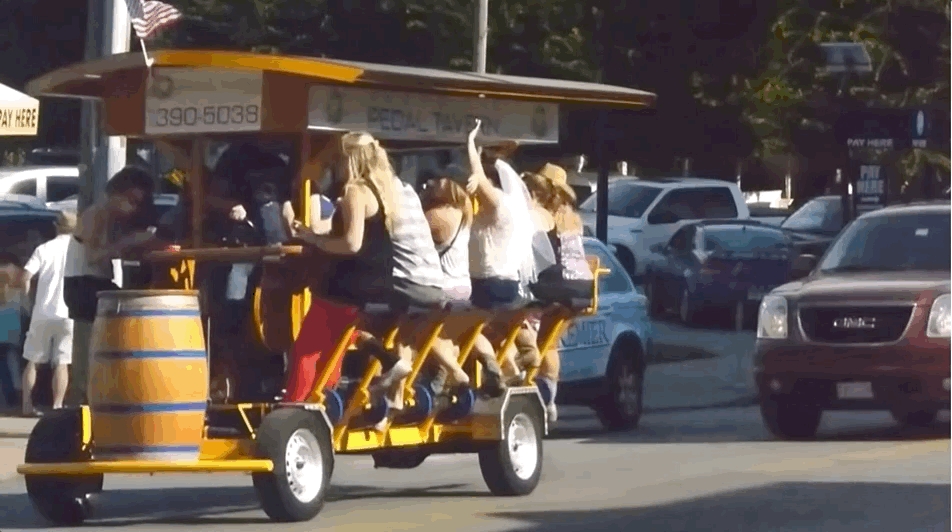 A bachelorette party holds up traffic while riding a pedal tavern in downtown Nashville.