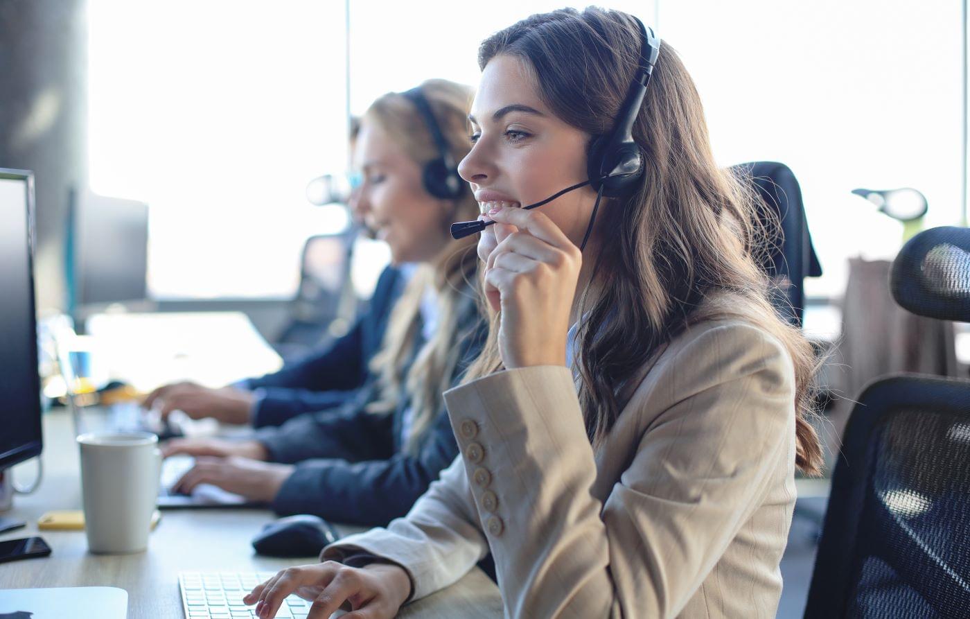 Women with phone headset doing telemarketing.