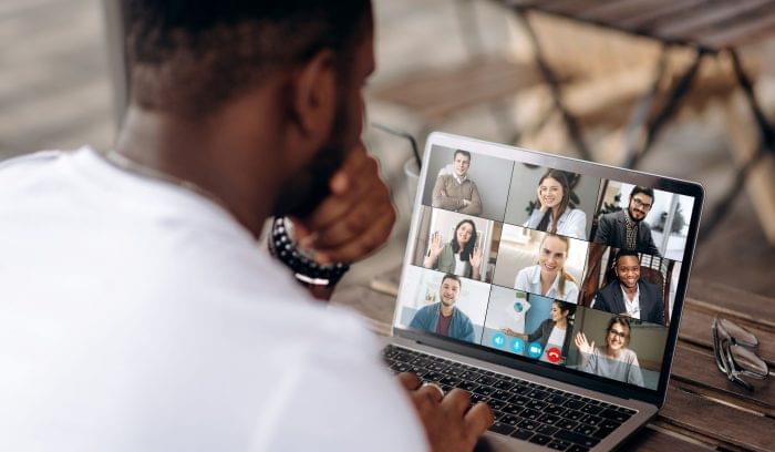 Man getting to know his team through web conferencing software during remote onboarding.