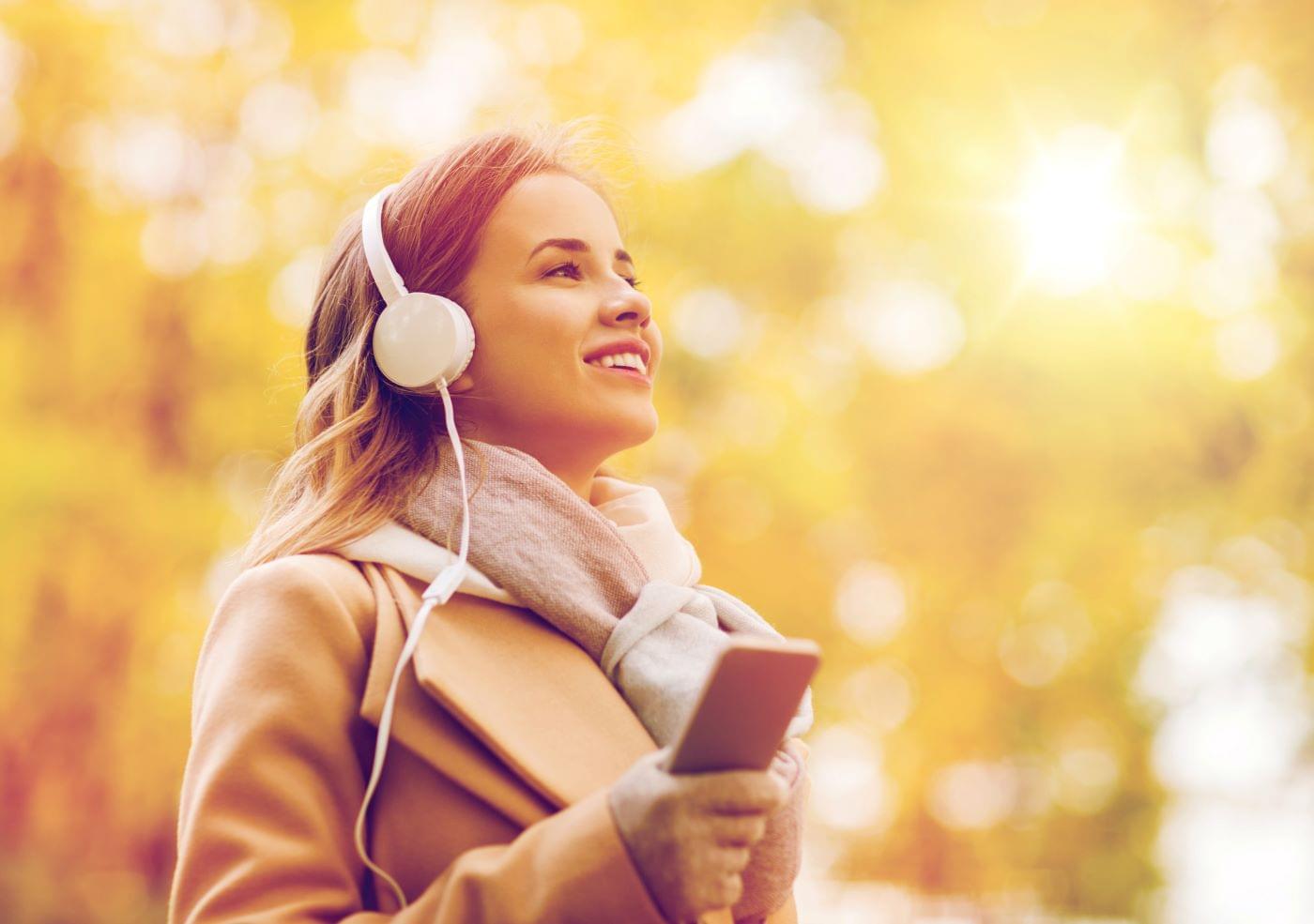 Woman listening to a business podcast while she takes a walk.