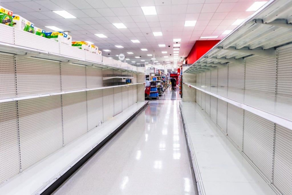 Empty grocery store shelves indicative of supply chain disruptions.