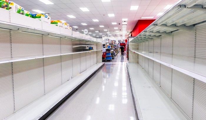 Empty grocery store shelves indicative of supply chain disruptions.