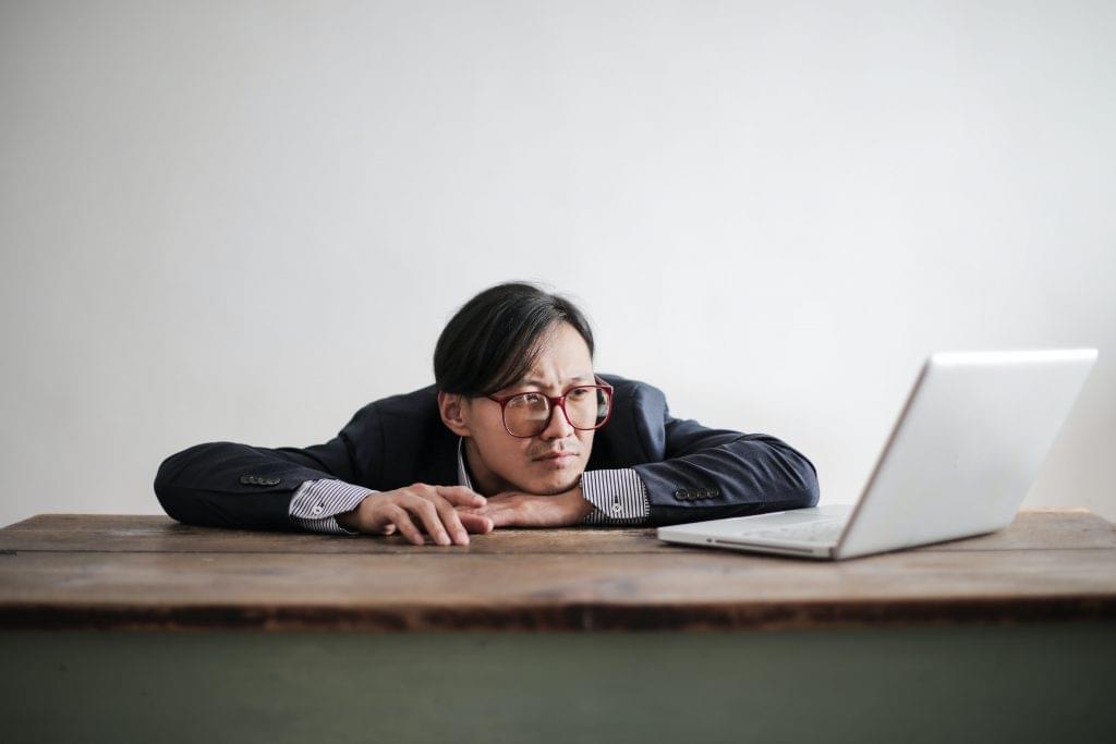 Frusrated man while using laptop.