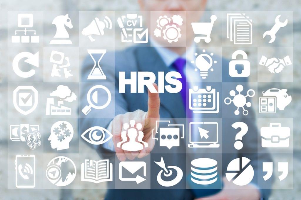 An HR professional touches an icon that says HRIS.