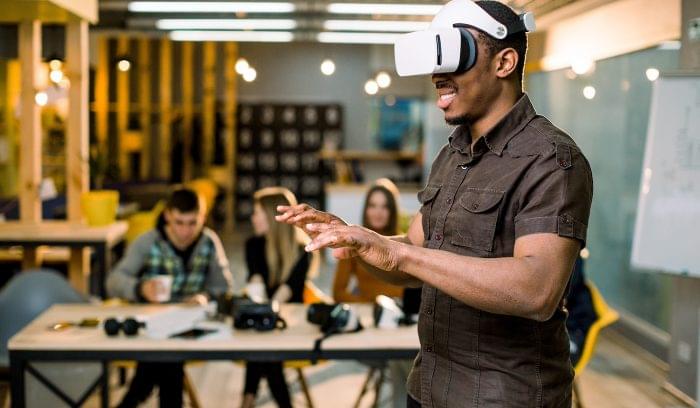 An employee uses a virtual reality headset during VR training.