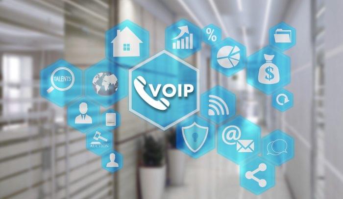 VOIP on the touch screen with a blur background of the office. The concept of Voice over Internet Protocol