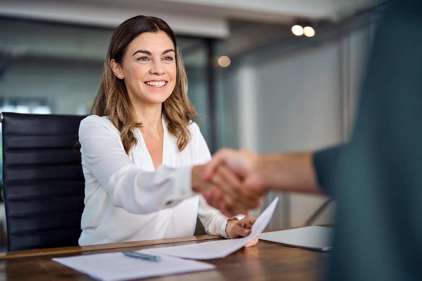 Happy employee shaking hands with manager